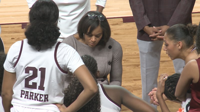 Texas A&M head women's basketball coach Joni Taylor draws up a play during a timeout.