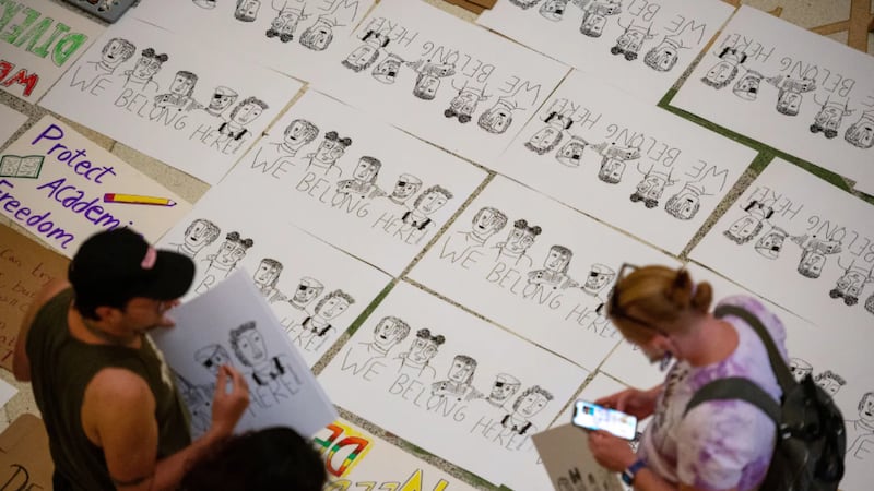 Illustrated posters reading “We Belong Here” sit on the Capitol’s rotunda floor during Texas...
