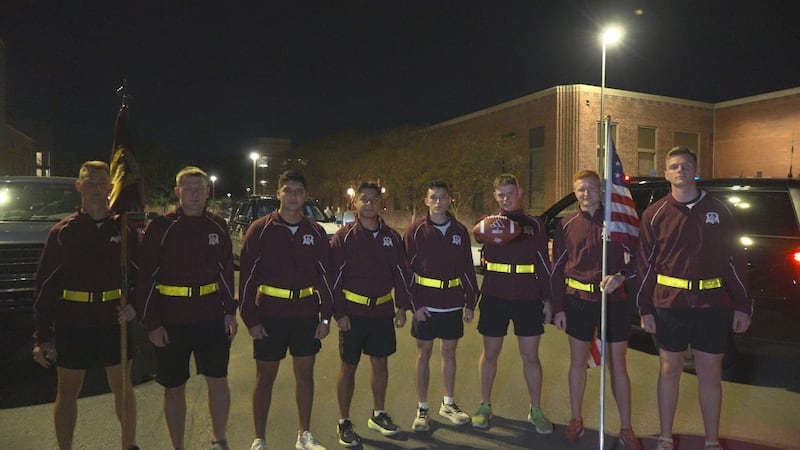 Texas A&M Corps of Cadets carrying the Lone Star Showdown game ball to Austin