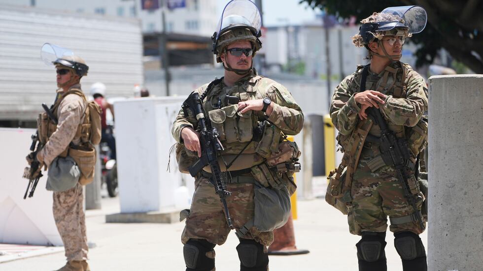 FILE - Members of the California National Guard and U.S. Marines guard a federal building on...